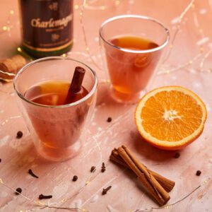 Hot mulled apple cider with fresh orange, cloves, and cinnamon.