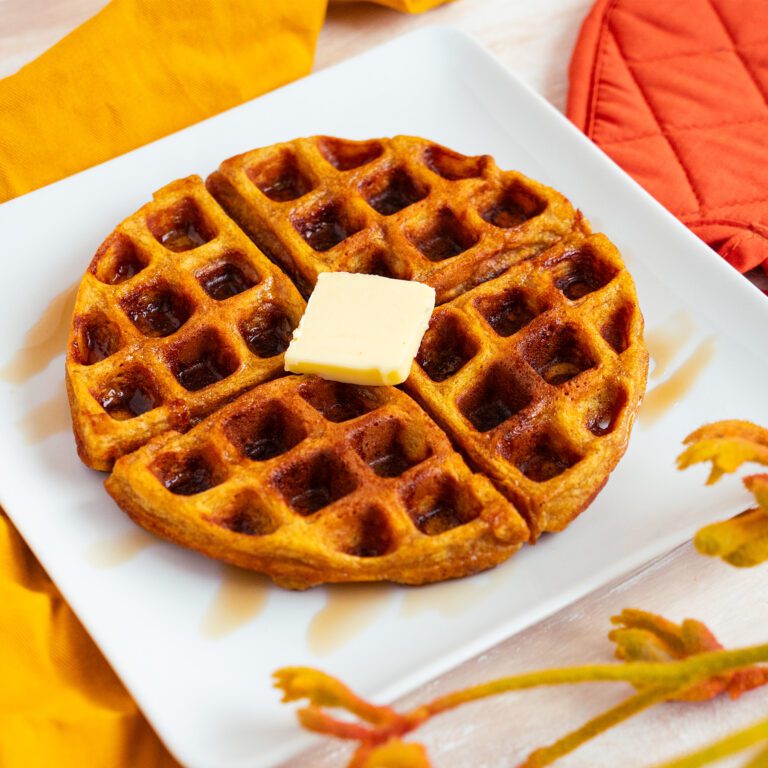 Pumpkin spice waffles with maple syrup and butter